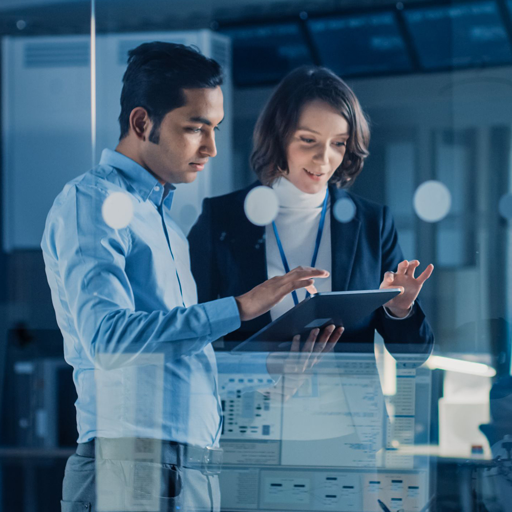 male and female software engineers working on tablet