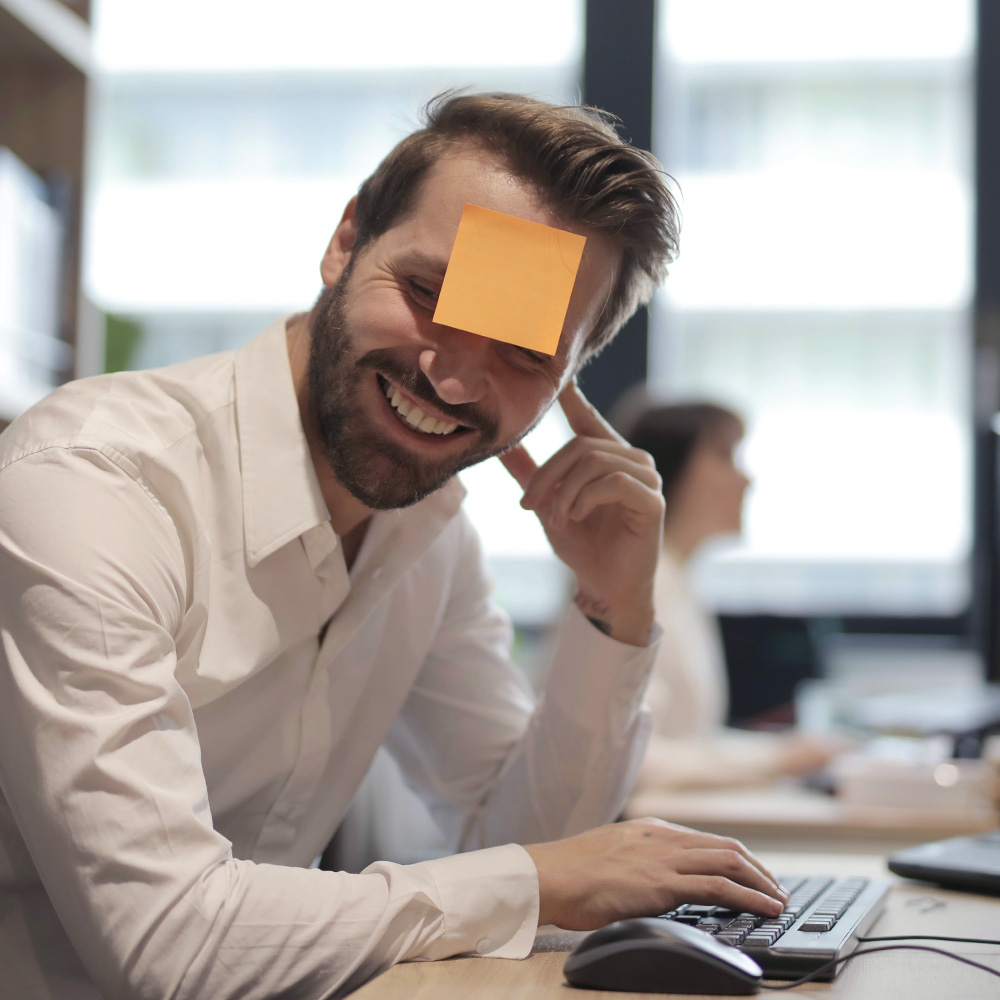 man with post it on forehead