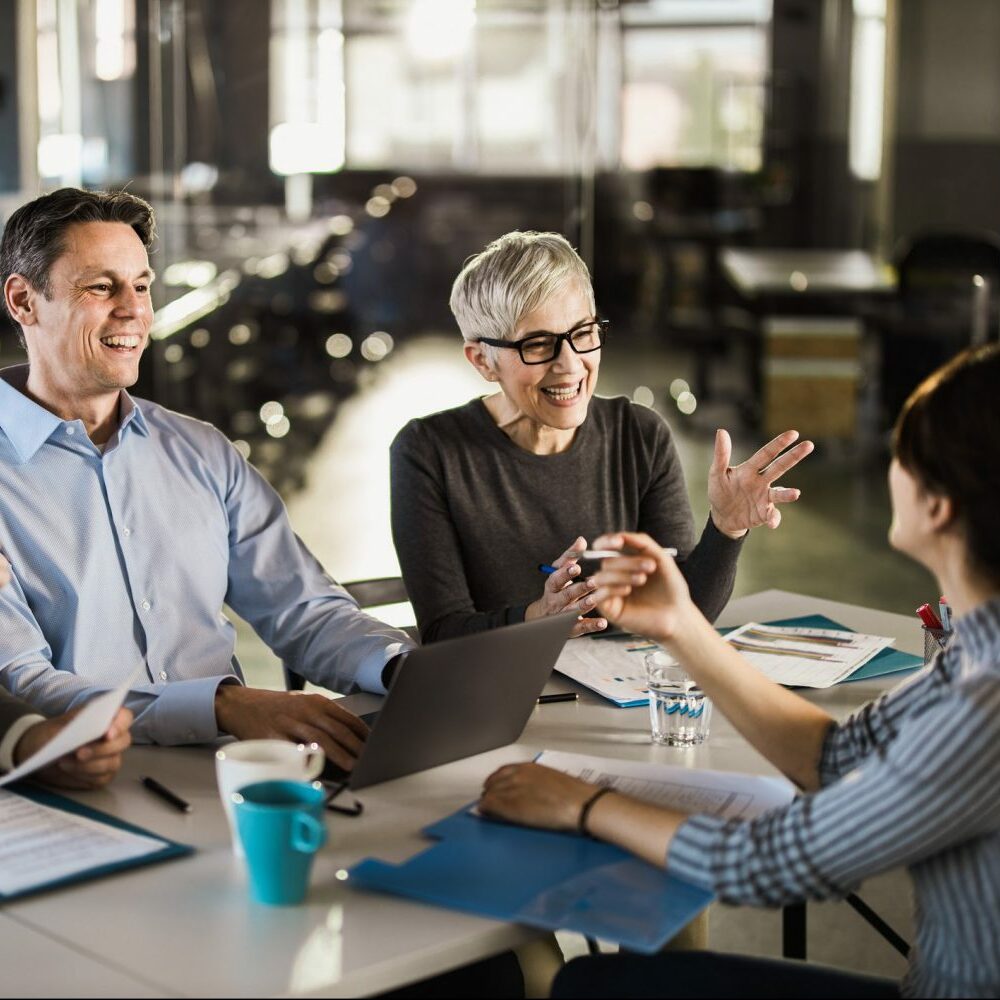 Happy business team talking to their candidate on a job interview in the office.