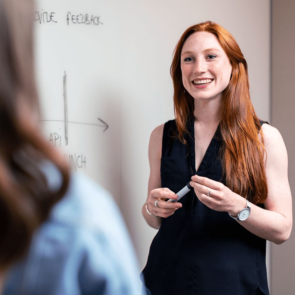 woman using whiteboard to plan project